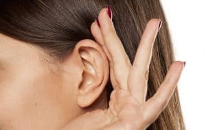 Close up of a hand over an ear